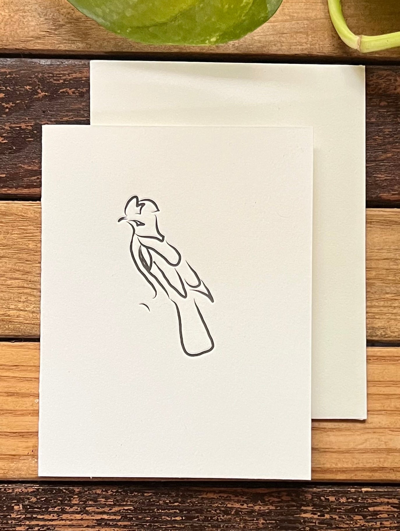 white card with abstract bird
