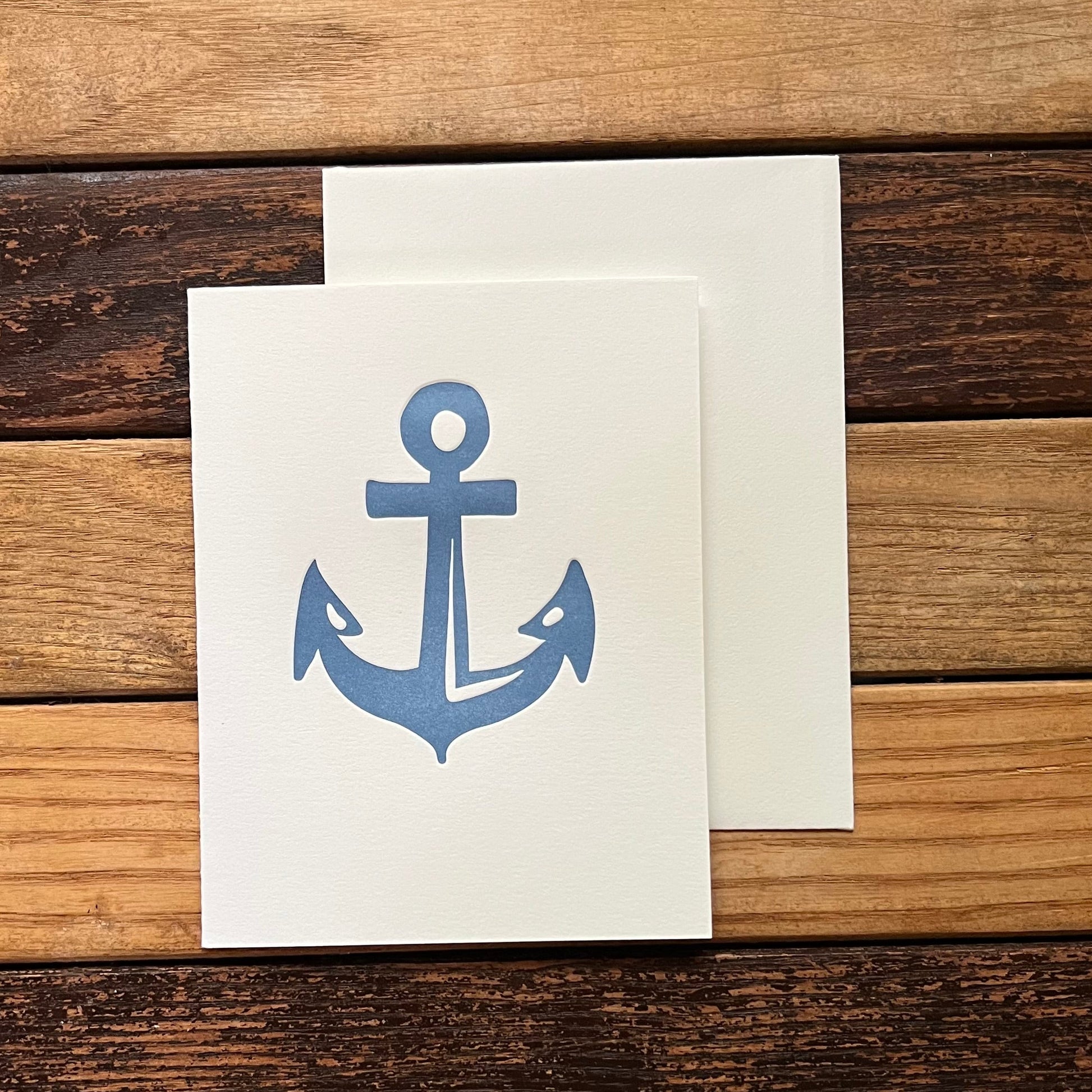 card with blue anchor designs on a wooden surface