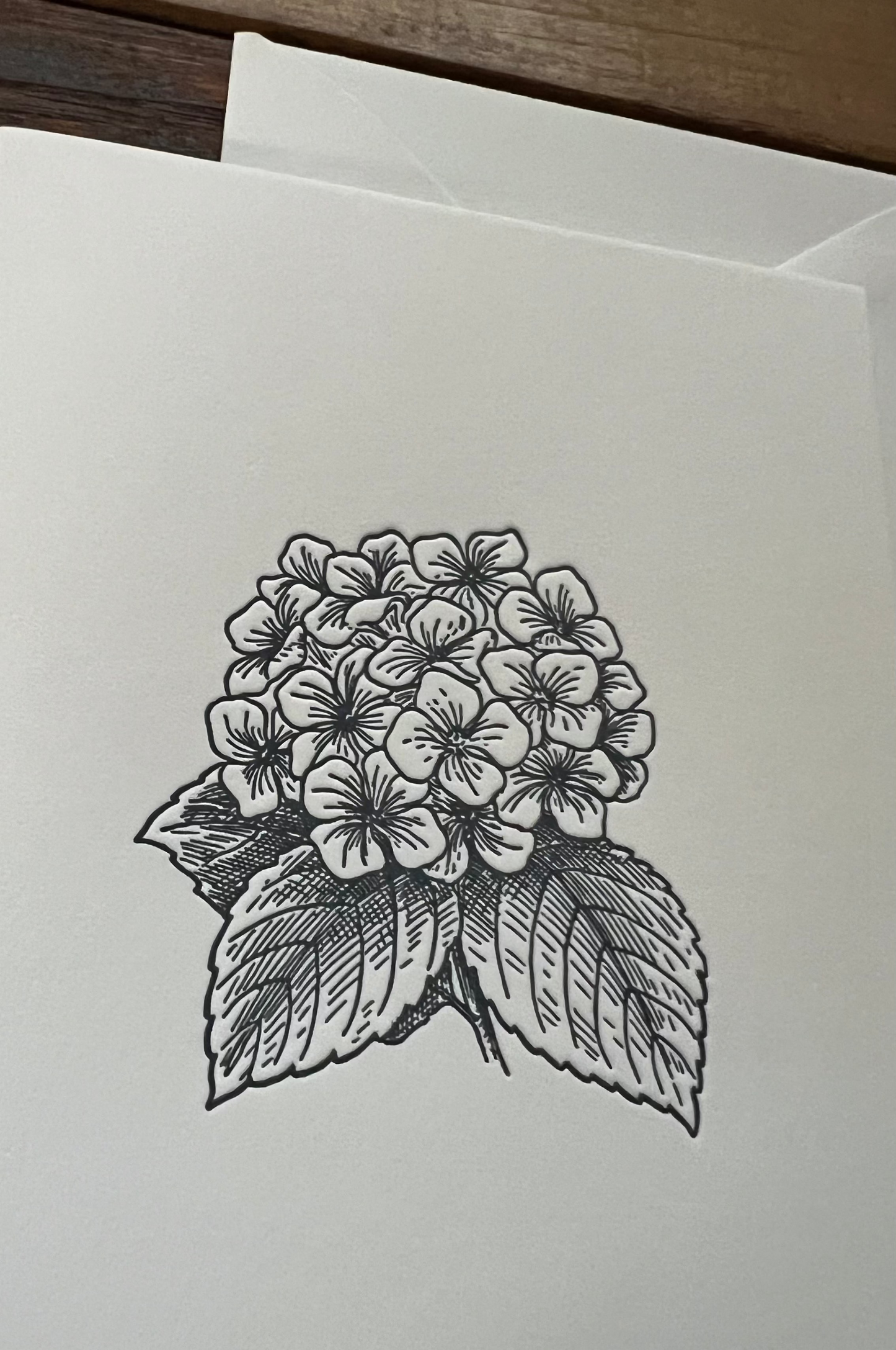 Greeting card with a black and white floral design on a plain background