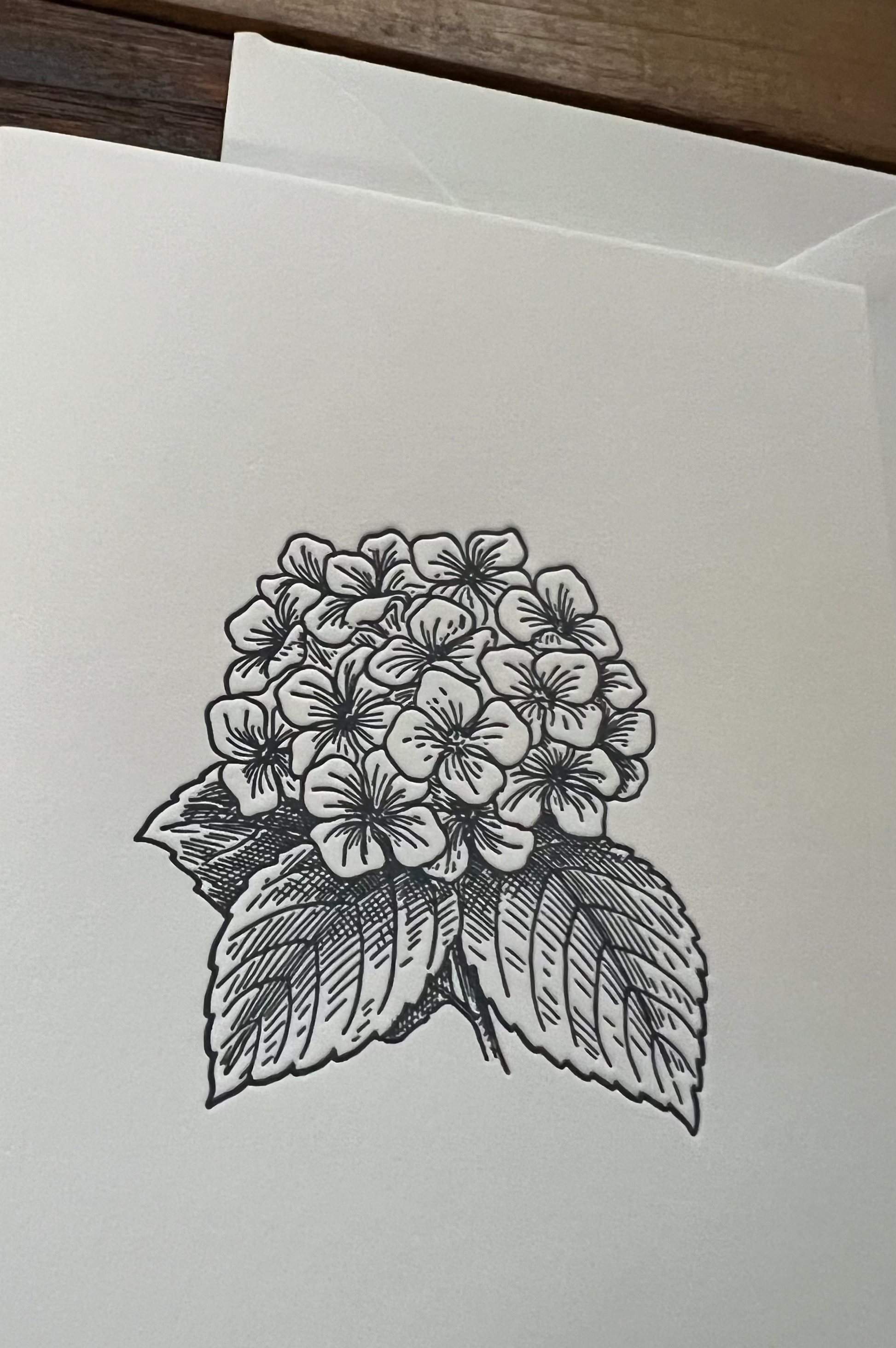 Greeting card with a black and white floral design on a plain background