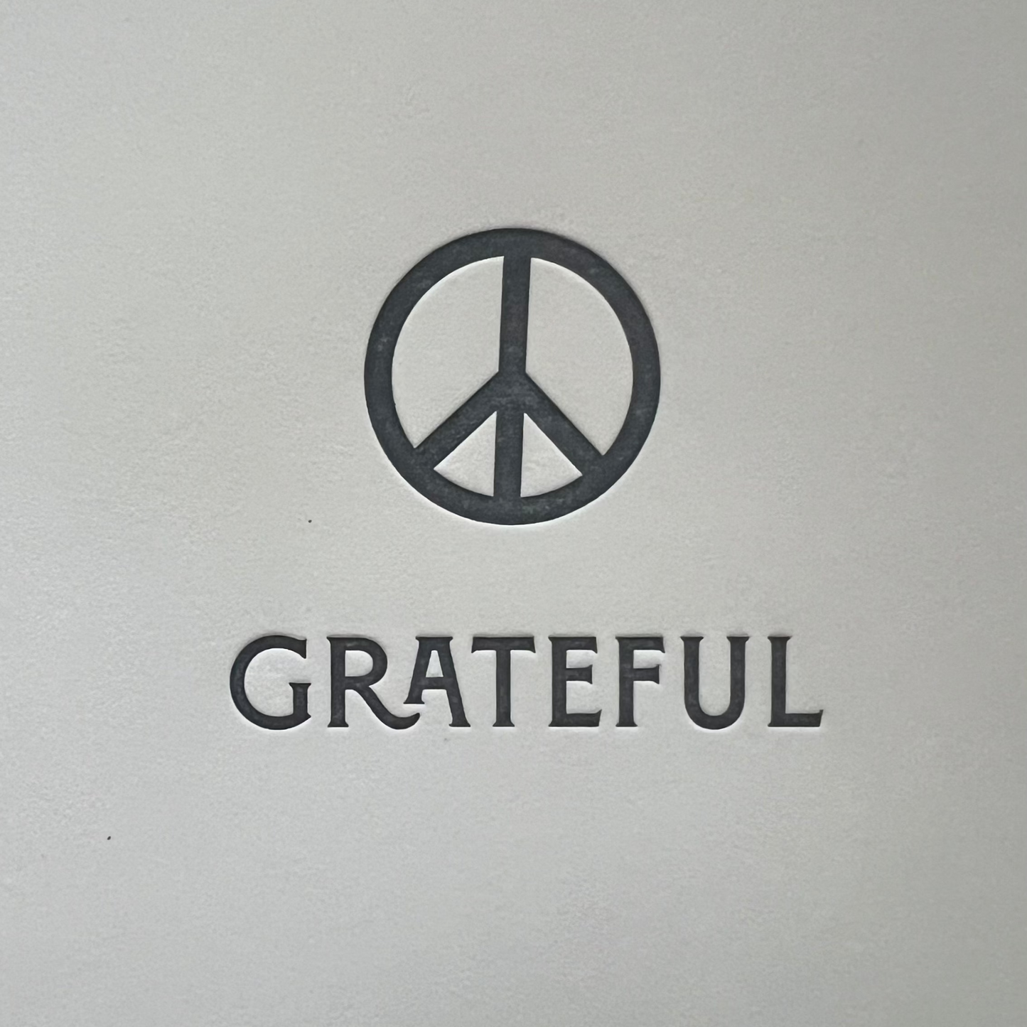 Peace symbol with 'GRATEFUL' text on a white background