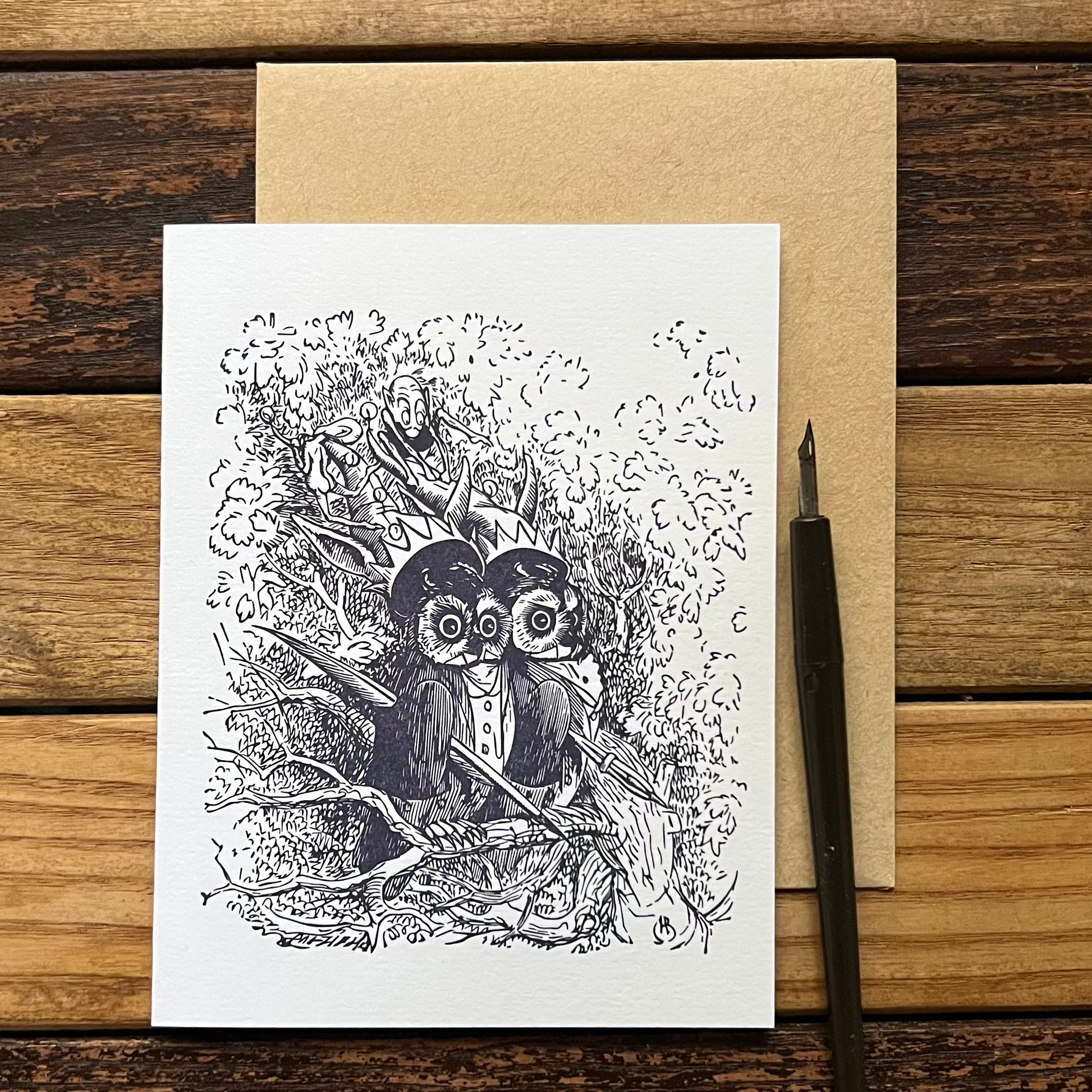 Greeting card with owl illustration on a wooden surface