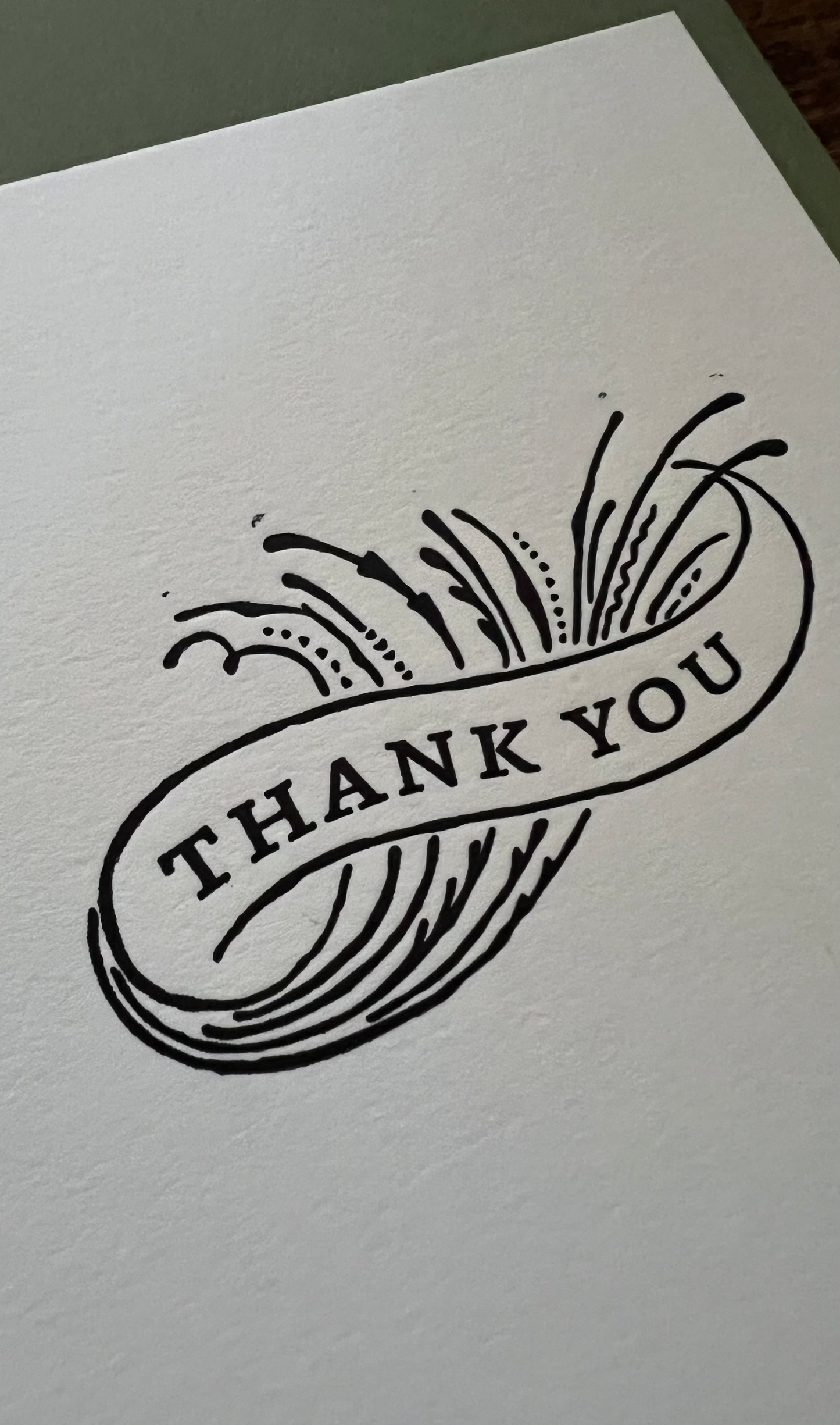 Card with 'Thank You' text on a plain background
