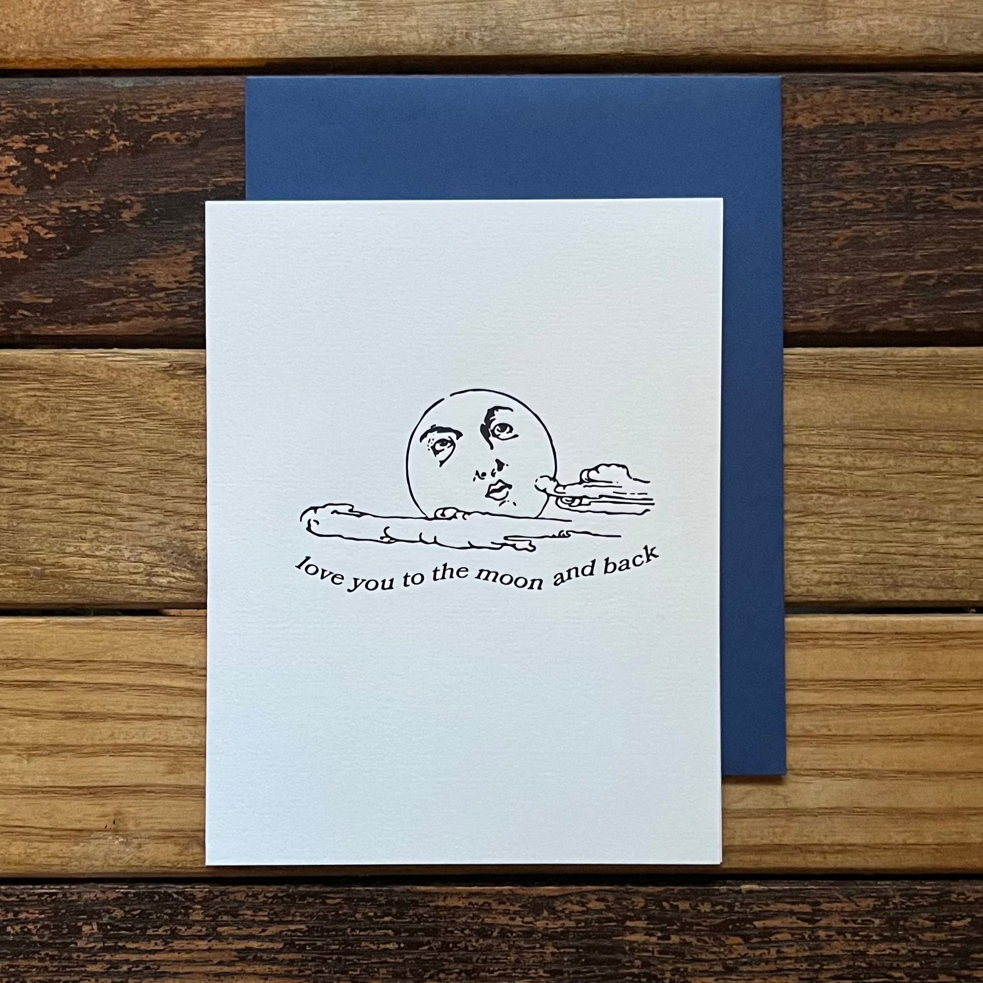 White card with black text and illustration on a wooden surface